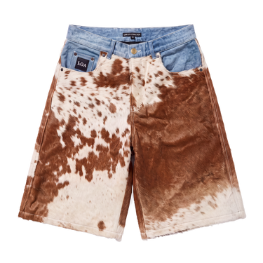 BROWN COWHIDE DENIM JORT — front flat showing hair-on cowhide, blue denim waistband and leather L.O.A tag