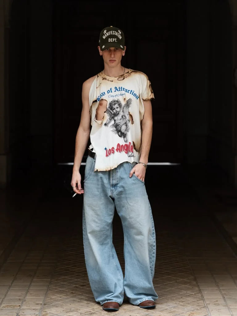 Model wearing Law of Attraction Los Angeles vintage shirt and Manifestation Dept hat